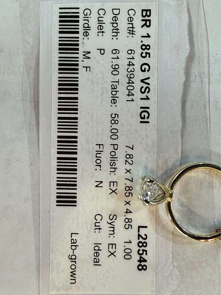 Diamond ring with certification label on a light gray background